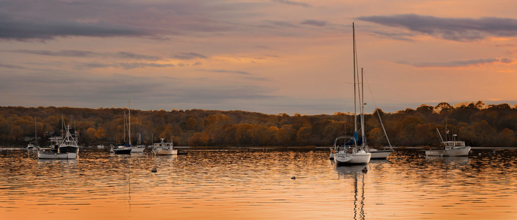 boats at mooring in Northport harbor at dusk in autumn colors Long Island ny visit Northport NY