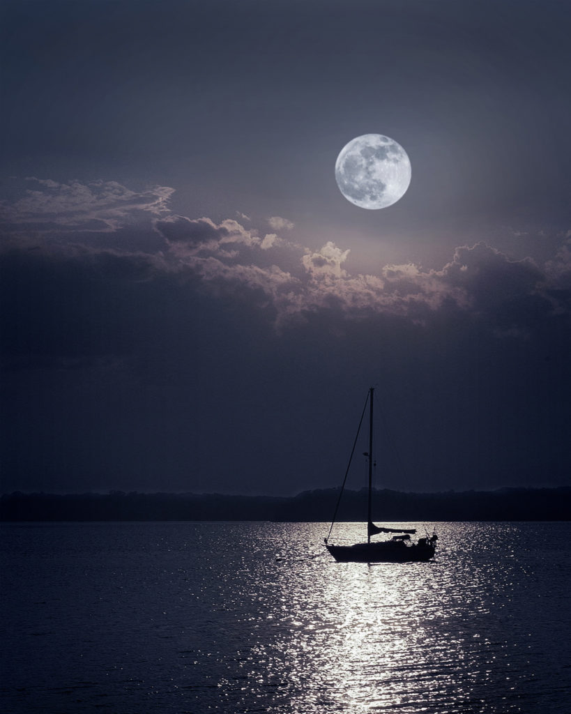 lone sailboat under the full moon off Asharoken beach Northport Bay Huntington Long Island New York travel vacation