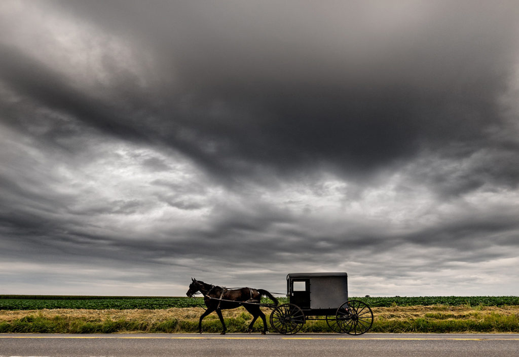 Amish lifestyle photography horse buggy on road storm images photos pics farmland culture